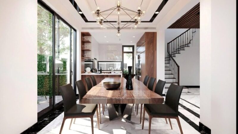 Để tạo nên vẻ đẹp tổng thể trong ý tưởng thiết kế không gian phòng ăn biệt thự Vinhomes Imperia Hải Phòng, việc sử dụng và sử dụng vật liệu lát nền lại càng được chú ý. Sử dụng chút nghệ thuật sắp đặt như trong mẫu bố trí trên đây, đá lát nền phòng ăn được bao bọc xung quanh bởi khung viền đá đen như thể hiện ranh giới rõ ràng giữa phòng ăn và phòng khách, phóng tầm mắt lên trên, bạn có thể thấy vẻ đẹp này được thể hiện đồng điệu khi trần thạch cao được trang trí thêm đường nét vuông vắn phối cùng đèn âm tường tạo hiệu ứng độc đáo cho không gian bếp. Đá lát nền